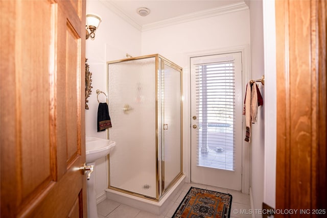 bathroom featuring crown molding, a stall shower, and tile patterned floors