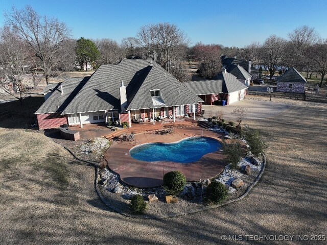 outdoor pool with a patio area