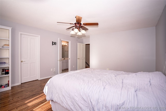 bedroom featuring ensuite bathroom, baseboards, wood finished floors, and a ceiling fan