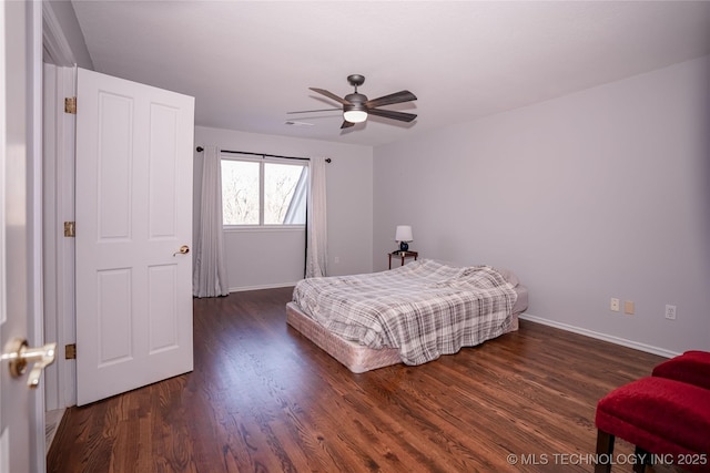 bedroom with a ceiling fan, wood finished floors, and baseboards