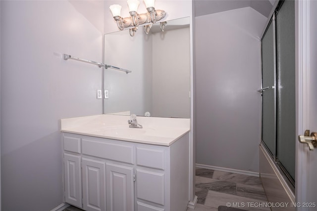 bathroom with baseboards, vanity, an inviting chandelier, and shower / bath combination with glass door