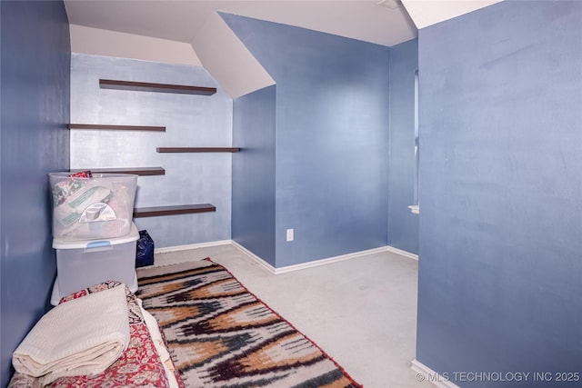 sitting room featuring baseboards and carpet