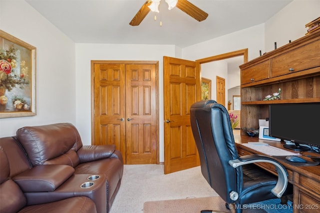 office space featuring light carpet and ceiling fan