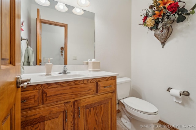 bathroom with tile patterned flooring, toilet, and vanity