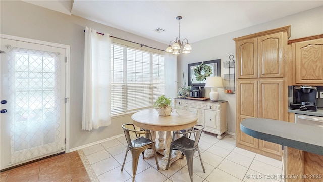 dining room featuring light tile patterned flooring, visible vents, baseboards, and an inviting chandelier