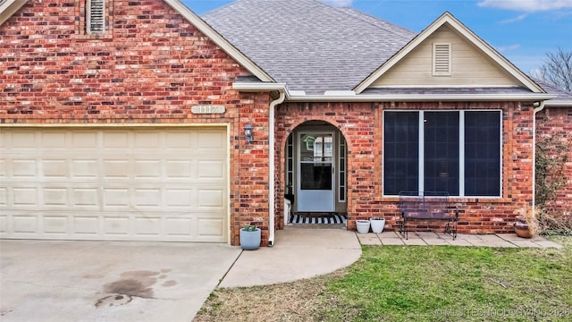 view of front of property with brick siding, a garage, concrete driveway, and roof with shingles