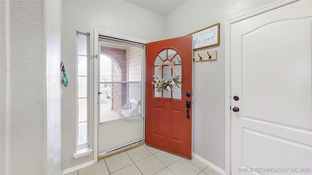 foyer entrance featuring light tile patterned flooring