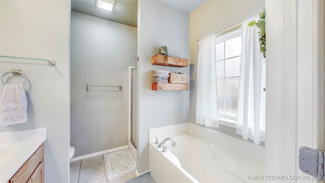 full bathroom featuring tile patterned floors, toilet, a stall shower, a bath, and vanity