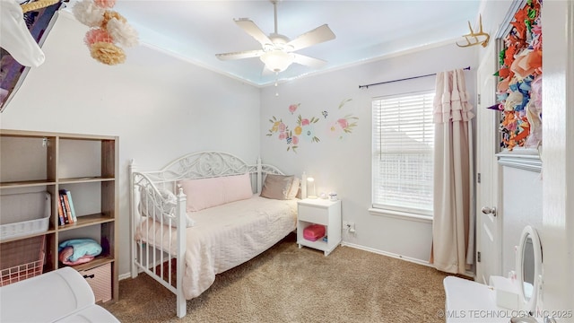 carpeted bedroom featuring baseboards and a ceiling fan