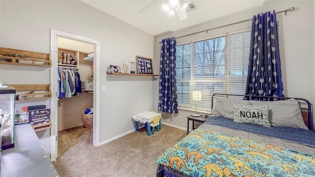 carpeted bedroom featuring visible vents, a closet, baseboards, ceiling fan, and a spacious closet