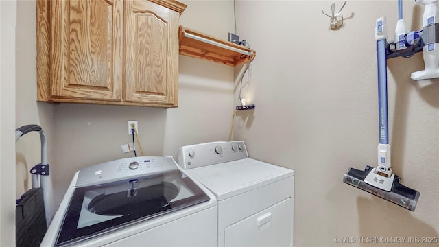 laundry room featuring cabinet space and separate washer and dryer