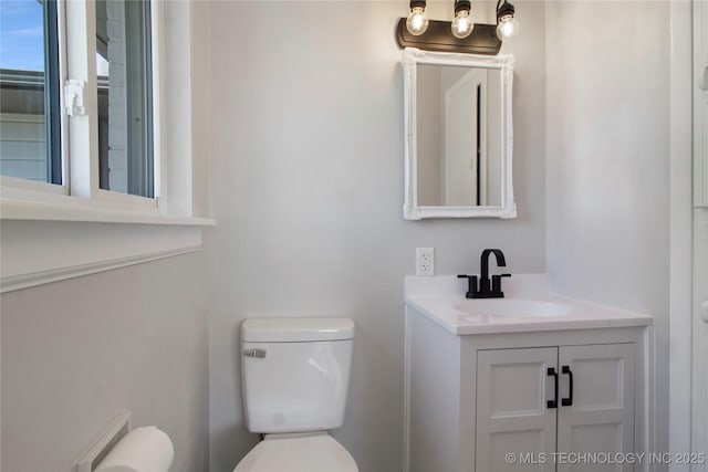 bathroom featuring toilet and vanity