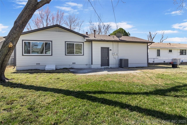 rear view of property featuring a patio, cooling unit, fence, crawl space, and a lawn