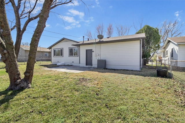 rear view of property with a fenced backyard, a patio, central AC, and a yard