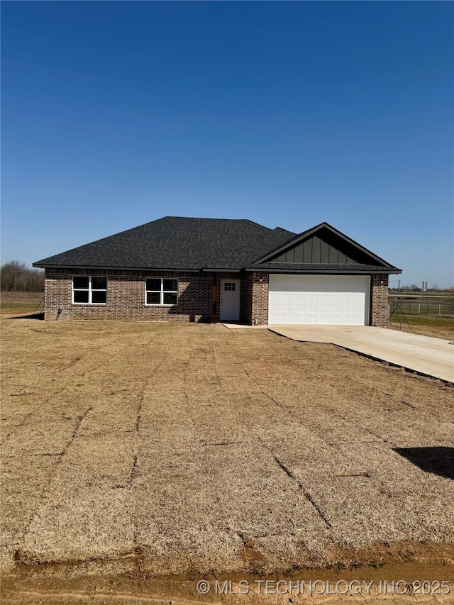 single story home featuring an attached garage, brick siding, board and batten siding, and driveway