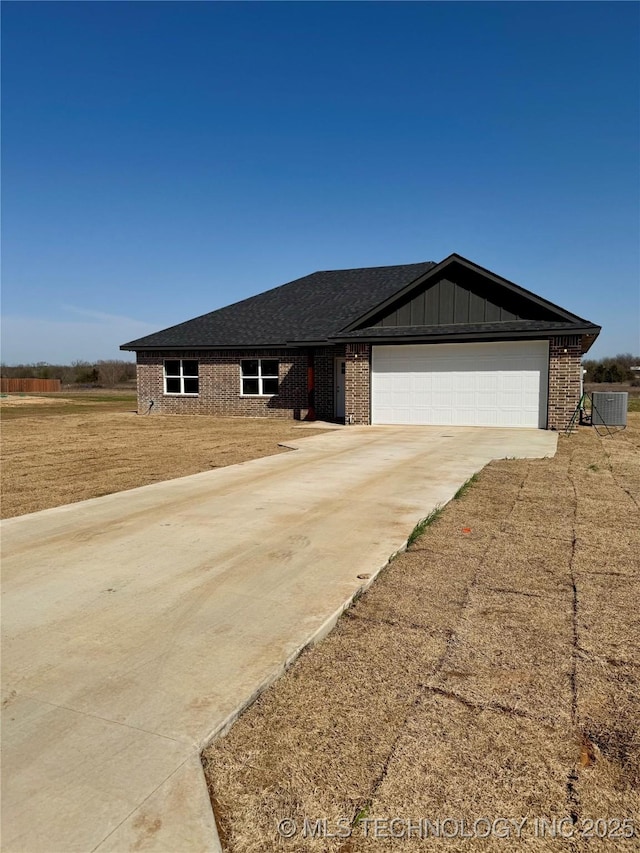 single story home with a garage, brick siding, board and batten siding, and driveway