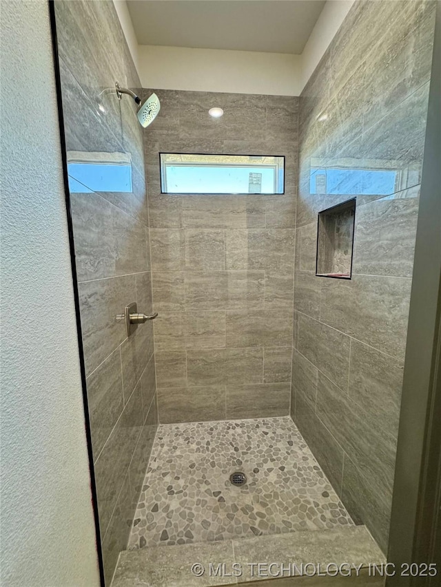 bathroom with a tile shower