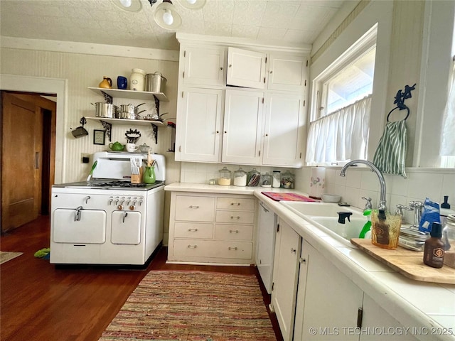 kitchen with range with gas stovetop, an ornate ceiling, a sink, light countertops, and white cabinetry