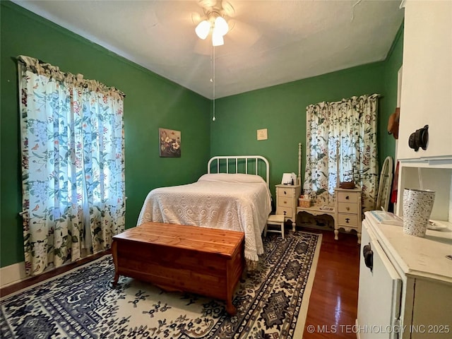 bedroom featuring a ceiling fan and dark wood-style flooring