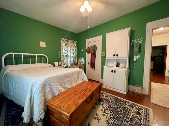 bedroom with wood finished floors and a ceiling fan