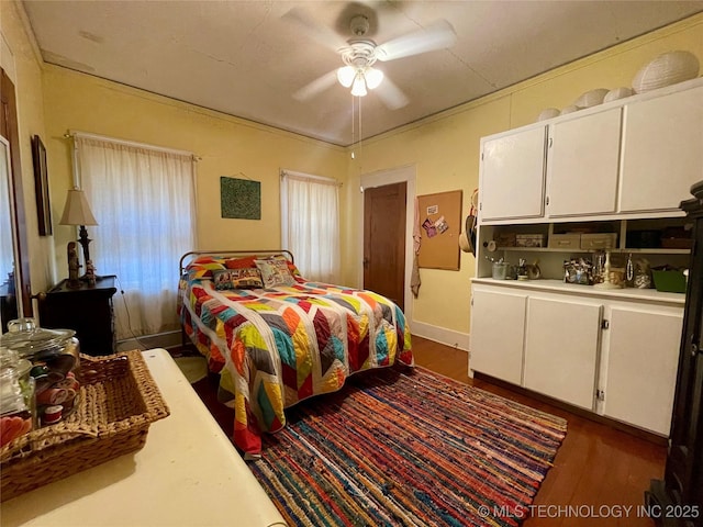 bedroom with dark wood finished floors and a ceiling fan