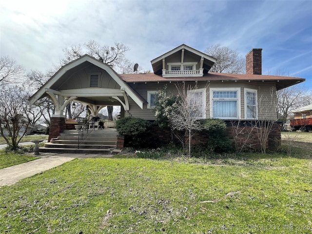 view of front facade featuring a chimney and a front yard