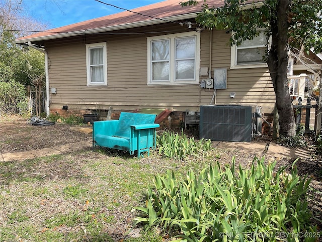 back of house with crawl space and central air condition unit