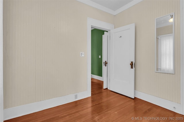 unfurnished room featuring wood finished floors and baseboards