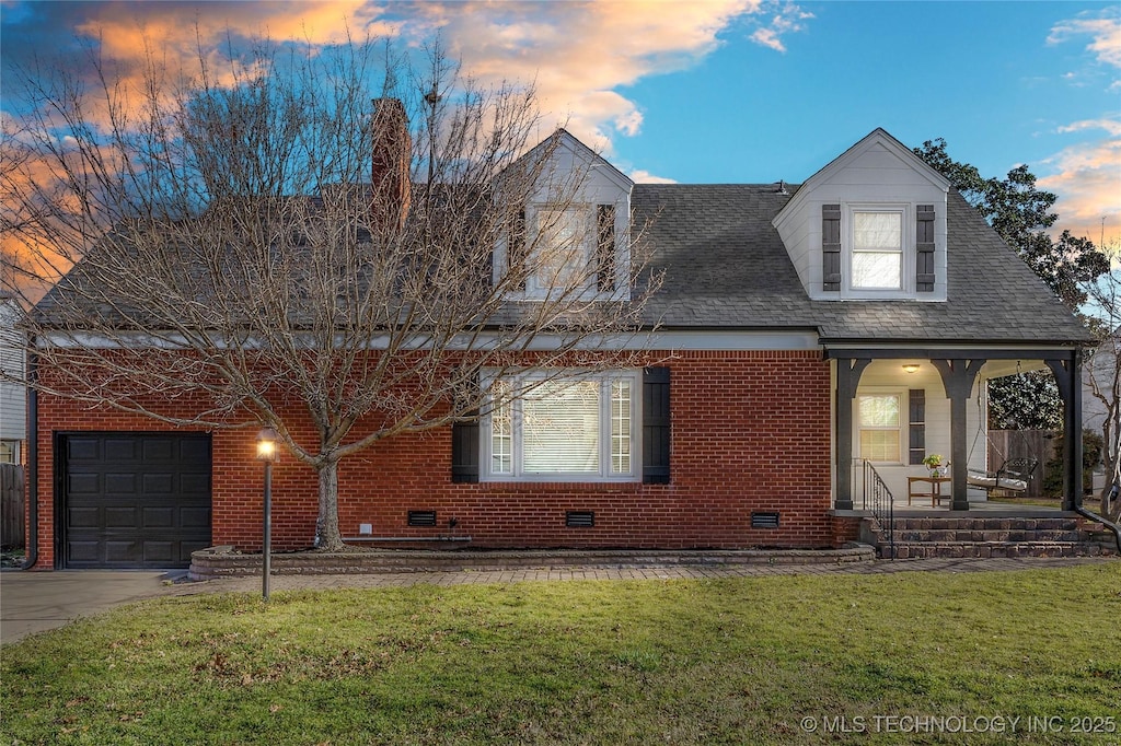 view of front facade featuring crawl space, covered porch, an attached garage, and a front yard