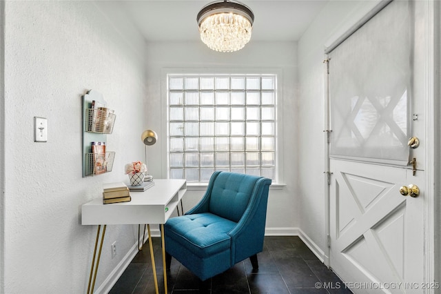 home office featuring a notable chandelier, dark tile patterned flooring, plenty of natural light, and baseboards