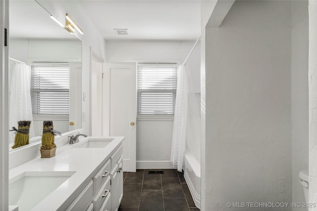 bathroom with tile patterned floors, double vanity, visible vents, and a sink