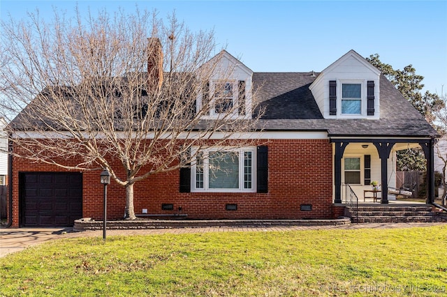 view of front of house featuring a garage, covered porch, a front yard, and a shingled roof