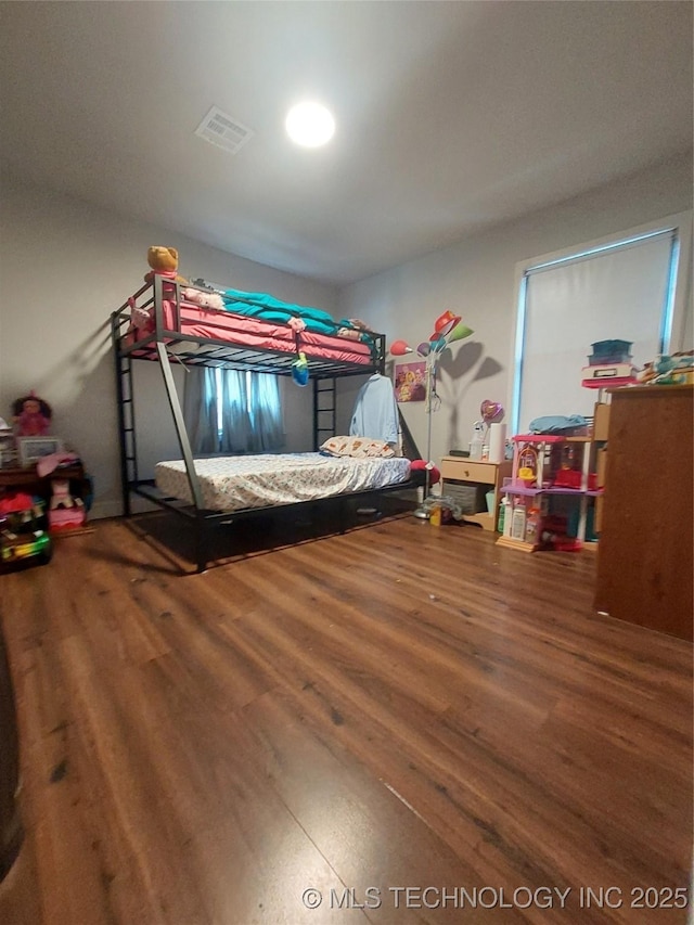 bedroom with wood finished floors and visible vents