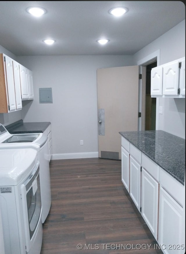 washroom featuring baseboards, dark wood finished floors, recessed lighting, washer and dryer, and cabinet space