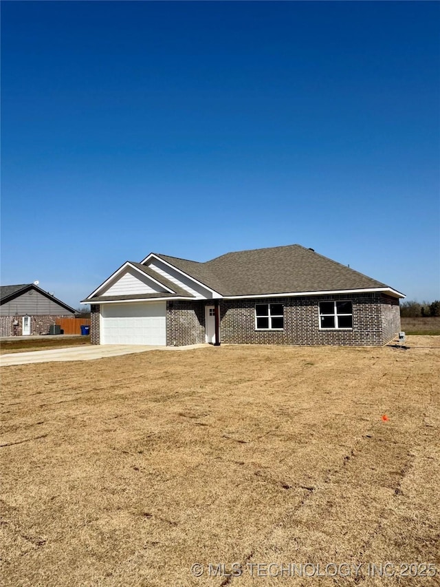 single story home with driveway, a front lawn, and a garage