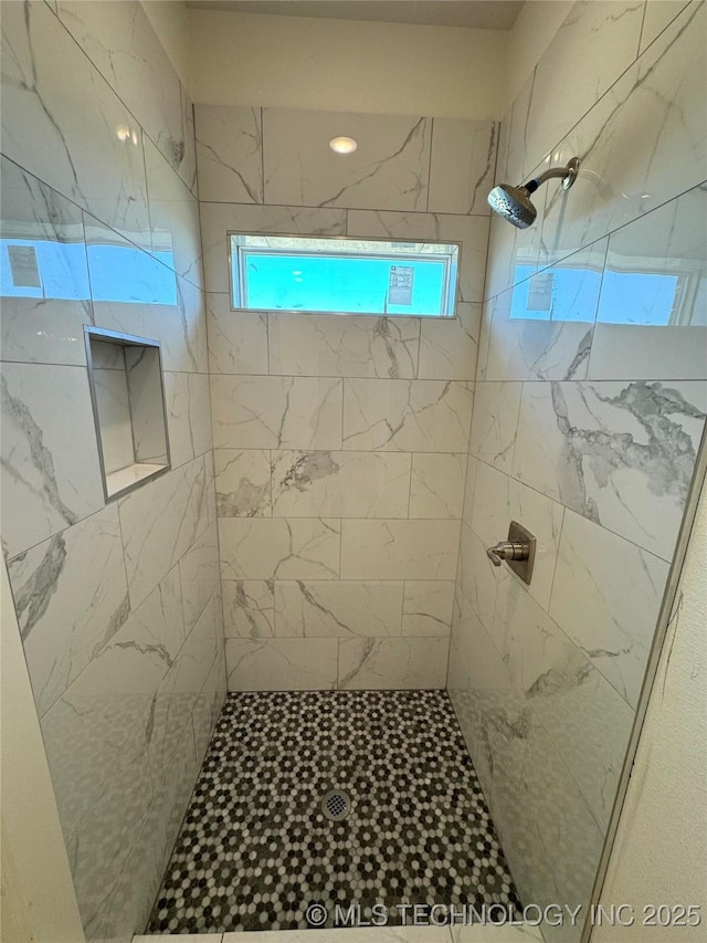 full bath with tiled shower