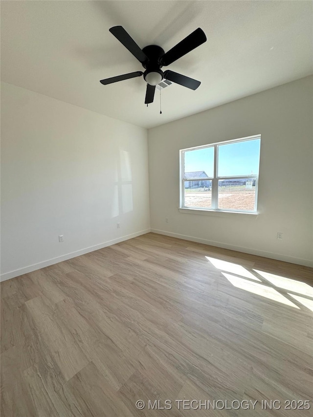 empty room with light wood finished floors, ceiling fan, and baseboards