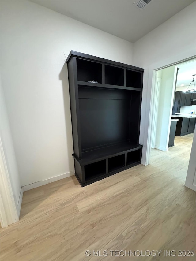 mudroom with light wood-type flooring and baseboards