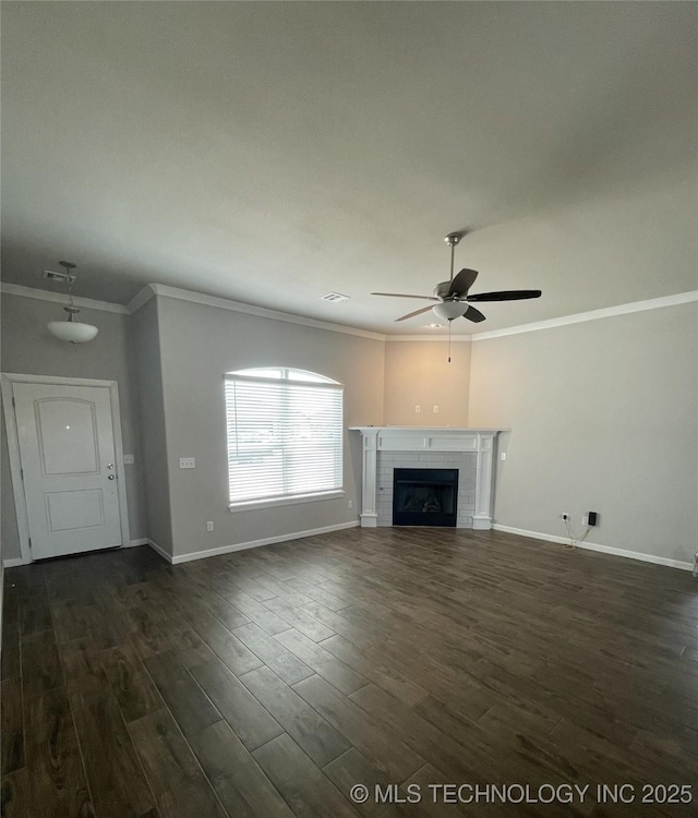 unfurnished living room with baseboards, ceiling fan, ornamental molding, a fireplace, and dark wood-style floors