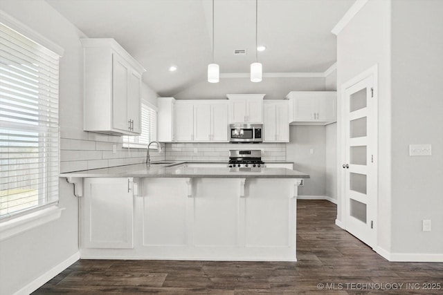 408 S 48th Ct S, Broken Arrow, OK 74014 - kitchen with a sink, tasteful backsplash, appliances with stainless steel finishes, a peninsula, and white cabinets