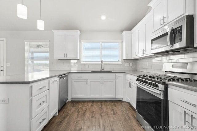 408 S 48th Ct S, Broken Arrow, OK 74014 - kitchen with white cabinetry, a peninsula, a sink, and stainless steel appliances