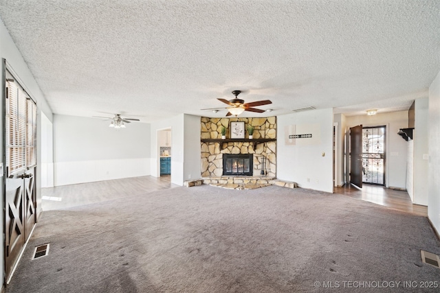 unfurnished living room with visible vents, carpet flooring, and ceiling fan