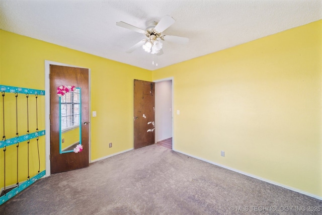 unfurnished bedroom with ceiling fan and carpet floors