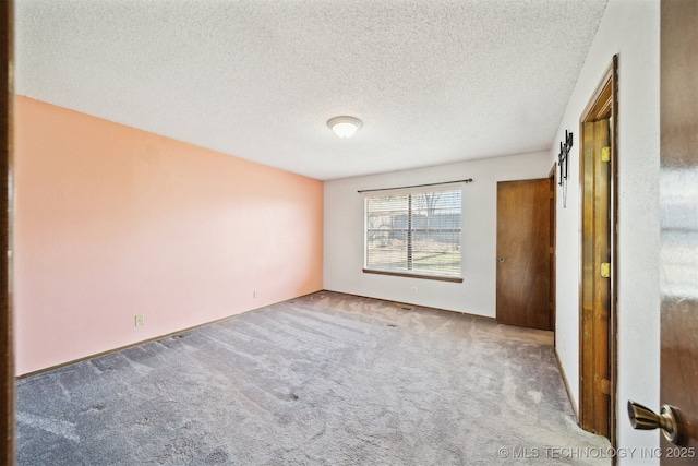 unfurnished bedroom featuring carpet floors and a textured ceiling