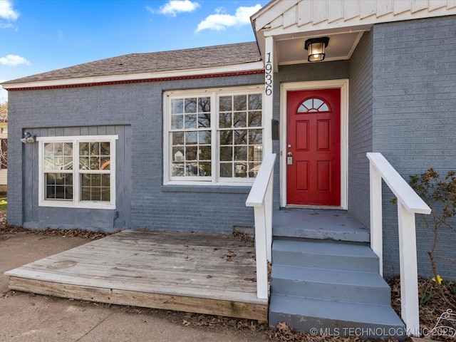 property entrance featuring brick siding