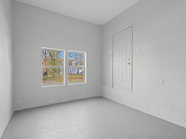 unfurnished room with concrete floors