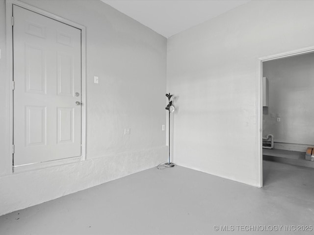 unfurnished room featuring finished concrete flooring