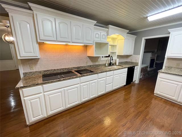 kitchen featuring dark wood finished floors, ornamental molding, decorative backsplash, black appliances, and a sink