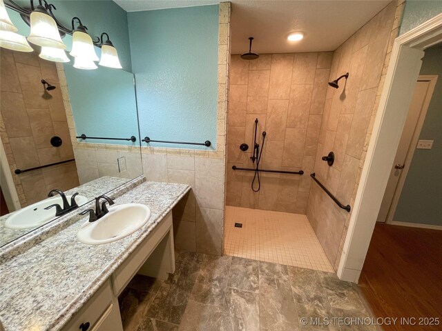 bathroom with vanity, tile walls, and walk in shower