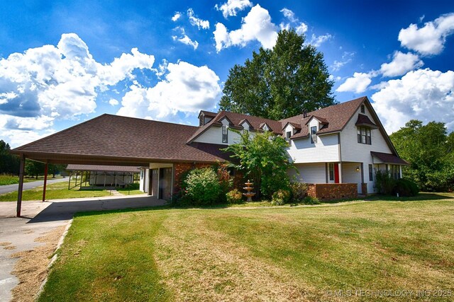 view of front of property featuring a carport, concrete driveway, a front yard, and brick siding